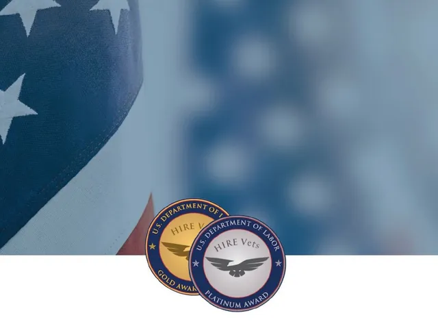 U.S. Department of Labor HIRE Vets Gold Award and Platinum Award medallions in front of a close-up of an American flag