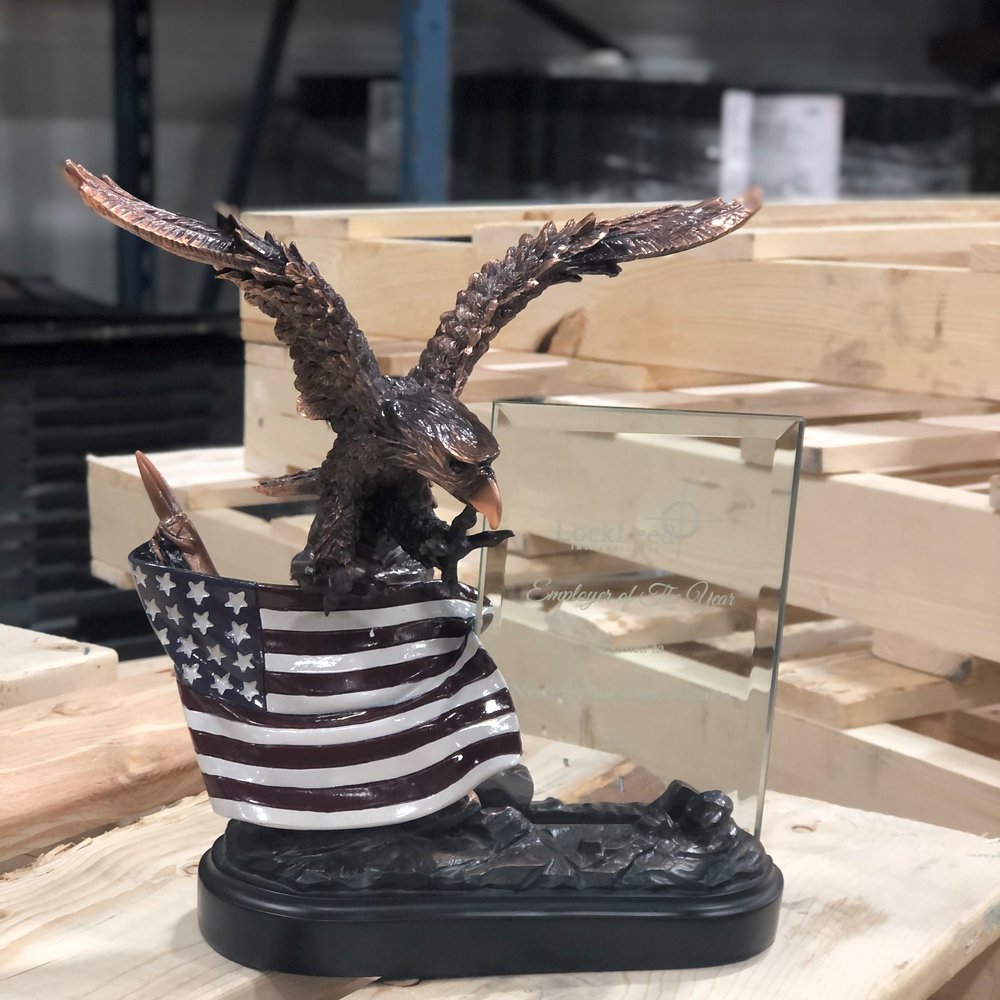Bronze eagle trophy with a painted American flag and an etched glass LockLeed Employer of the Year plaque