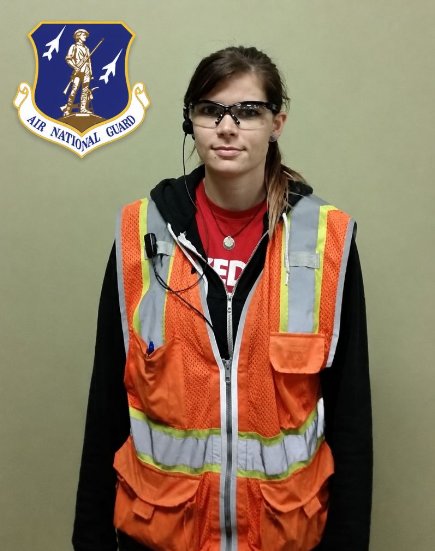 Melody Fastner in a high-visibility vest and safety glasses