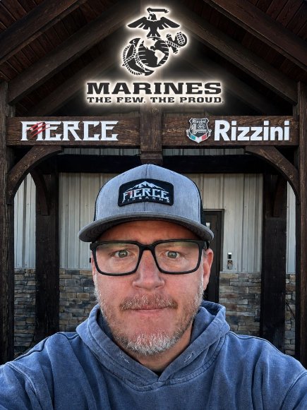 Pete Hanson in a Fierce cap beneath a Marines sign