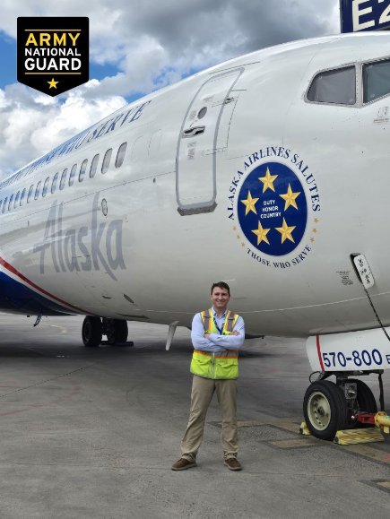 Thomas Lochen in a safety vest beside an Alaska Airlines jet