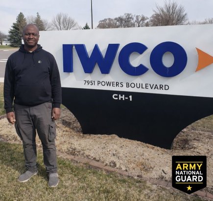 William Nguma beside the IWCO sign